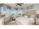 Bright bedroom features large windows, neutral tones, and stylish decor creating a cozy atmosphere at 1806 Longliner Loop, Wesley Chapel, FL 33543