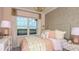 Bright bedroom featuring a large window and beautiful interior design with pink accents and geometric patterns at 1806 Longliner Loop, Wesley Chapel, FL 33543