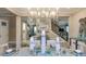 Open concept dining room with modern chandelier and view of the staircase at 1806 Longliner Loop, Wesley Chapel, FL 33543