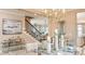 Elegant dining room with a chandelier, dining table setting, and view of the staircase and adjacent living areas at 1806 Longliner Loop, Wesley Chapel, FL 33543