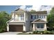 Charming two-story home featuring a two car garage and a balcony with white railings at 1806 Longliner Loop, Wesley Chapel, FL 33543