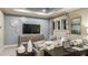 Relaxing living area features a comfortable couch, modern TV and ample seating at 1806 Longliner Loop, Wesley Chapel, FL 33543