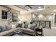 Comfortable living room area with a large sectional sofa, soft lighting, and decorative accents at 1806 Longliner Loop, Wesley Chapel, FL 33543