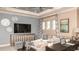 Comfortable living room with large sofa, television, and decorative wall art at 1806 Longliner Loop, Wesley Chapel, FL 33543