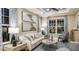 Bright living room with large windows, a comfortable sofa, and stylish decor at 1806 Longliner Loop, Wesley Chapel, FL 33543