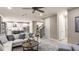 Spacious living area with open layout, seamless flow into kitchen, and elegant staircase at 1806 Longliner Loop, Wesley Chapel, FL 33543