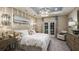 Cozy main bedroom with soft lighting, a comfortable bed, and elegant furnishings at 1806 Longliner Loop, Wesley Chapel, FL 33543