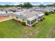 An aerial view of a single story home with enclosed patio, surrounded by mature landscaping at 201 Bedford St # 79, Sun City Center, FL 33573