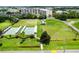 An aerial shot of tennis and shuffleboard courts with mature landscaping and manicured lawns at 201 Bedford St # 79, Sun City Center, FL 33573