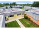 An aerial view of colorful homes, green lawns, with mature landscaping, and concrete walkways at 201 Bedford St # 79, Sun City Center, FL 33573