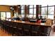 Upscale bar area with granite countertop, dark wood, barstool seating, and a wide selection of beverages at 201 Bedford St # 79, Sun City Center, FL 33573