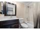 Bathroom with dark wood vanity, modern faucet, and shower-tub combo at 201 Bedford St # 79, Sun City Center, FL 33573