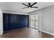 Bedroom with sliding glass doors, closet, and ceiling fan offering natural light and access to outdoor space at 201 Bedford St # 79, Sun City Center, FL 33573