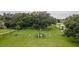 Aerial view of a fenced dog park featuring grassy areas, play structures, and seating within a community park setting at 201 Bedford St # 79, Sun City Center, FL 33573