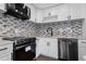 Updated kitchen boasts modern stainless steel appliances and elegant white cabinets with mosaic backsplash at 201 Bedford St # 79, Sun City Center, FL 33573
