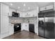 Updated kitchen boasts modern stainless steel appliances and elegant white cabinets with mosaic backsplash at 201 Bedford St # 79, Sun City Center, FL 33573
