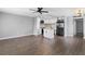 Open concept living room with a kitchen island, a ceiling fan, and modern appliances and backsplash at 201 Bedford St # 79, Sun City Center, FL 33573