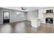 Well-lit living room features gray walls, wood flooring, and an island with white cabinets and speckled countertops at 201 Bedford St # 79, Sun City Center, FL 33573