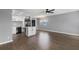 Spacious living room leading to a well-lit kitchen with stainless steel appliances and a kitchen island at 201 Bedford St # 79, Sun City Center, FL 33573