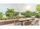Beautiful outdoor seating area featuring a table and chairs with a fountain and pond in the background at 201 Bedford St # 79, Sun City Center, FL 33573