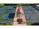 Multiple pickleball courts with players and a central gathering area with covered seating at 201 Bedford St # 79, Sun City Center, FL 33573