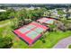 Aerial view of tennis courts, surrounded by lush greenery and trees at 201 Bedford St # 79, Sun City Center, FL 33573