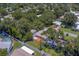 Lush backyard features a white fence, manicured lawn, and private deck at 2123 Indigo Dr, Clearwater, FL 33763