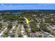Wide aerial perspective shows the home in its community setting near a lake at 2123 Indigo Dr, Clearwater, FL 33763