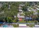 Scenic aerial shot showcases backyard with deck, white fence and manicured lawn at 2123 Indigo Dr, Clearwater, FL 33763