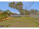 Fenced backyard featuring a wooden deck and a grassy lawn, perfect for outdoor activities at 2123 Indigo Dr, Clearwater, FL 33763