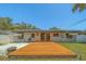 Enjoy outdoor living with a wooden deck connecting to a concrete patio in the serene backyard at 2123 Indigo Dr, Clearwater, FL 33763