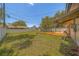 Expansive backyard with a wooden deck, lush grass, and a privacy fence, ideal for relaxation and recreation at 2123 Indigo Dr, Clearwater, FL 33763