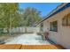 A spacious concrete patio with some seating, complemented by a wooden deck and a well-maintained fence at 2123 Indigo Dr, Clearwater, FL 33763