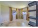 Bedroom with neutral walls, tile flooring, natural light from curtain-covered windows, and built-in shelving at 2123 Indigo Dr, Clearwater, FL 33763