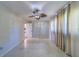Bedroom featuring bright walls, tile flooring, ceiling fan, curtains, closet, and adjoining room at 2123 Indigo Dr, Clearwater, FL 33763