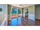 Bright dining room featuring wood floors, wainscoting, and sliding glass doors leading to a deck at 2123 Indigo Dr, Clearwater, FL 33763