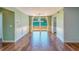 Dining room with wood-look tile flooring, white wainscotting, and sliding doors to deck at 2123 Indigo Dr, Clearwater, FL 33763