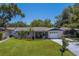 Charming single-story home with manicured lawn, tile roof, and attached garage at 2123 Indigo Dr, Clearwater, FL 33763