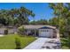 Charming single-story home with manicured lawn, tile roof, and attached garage at 2123 Indigo Dr, Clearwater, FL 33763