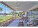 Relaxing front porch featuring comfortable seating, complemented by the well-maintained front yard at 2123 Indigo Dr, Clearwater, FL 33763