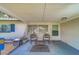 Inviting porch with a seating area including two chairs and a small table, perfect for relaxing outdoors at 2123 Indigo Dr, Clearwater, FL 33763