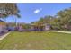 Inviting curb appeal with a well-manicured lawn and garden beds, complemented by a charming single-story home at 2123 Indigo Dr, Clearwater, FL 33763