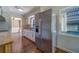 Kitchen area with stainless steel refrigerator, white cabinets, and window view at 2123 Indigo Dr, Clearwater, FL 33763