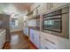 Kitchen featuring stainless steel oven, white cabinets and wooden countertops at 2123 Indigo Dr, Clearwater, FL 33763