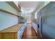 Spacious kitchen featuring wooden countertops, stainless steel refrigerator, and tile flooring at 2123 Indigo Dr, Clearwater, FL 33763