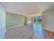 Open living room boasts neutral paint, modern lighting, and sliding glass doors to the backyard deck at 2123 Indigo Dr, Clearwater, FL 33763