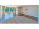 Bright living room features tile floors, neutral walls, and sliding doors to a wooden deck at 2123 Indigo Dr, Clearwater, FL 33763