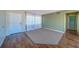 Neutral living area features tile flooring, carpet insert, and well-lit, airy space at 2123 Indigo Dr, Clearwater, FL 33763