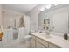 Bathroom with walk-in tub, shower, and well-lit vanity, providing accessibility and comfort at 2192 Swedish Dr # 26, Clearwater, FL 33763