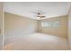 Bright bedroom featuring neutral walls, carpet, ceiling fan and a large window at 2192 Swedish Dr # 26, Clearwater, FL 33763